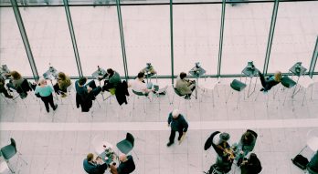People sitting at tables in a well lit area