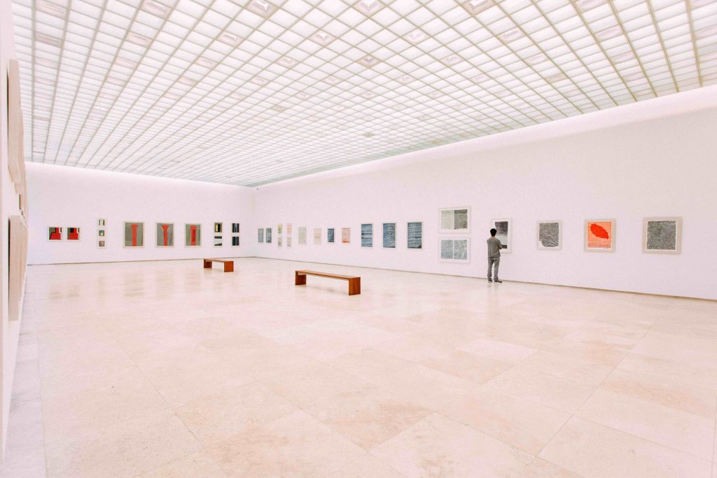 Viewer in a large, white art gallery